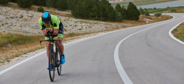 istock triathlon athlete riding bike 1276874501