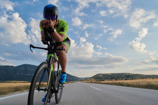 istock triathlon athlete riding bike 1276874504