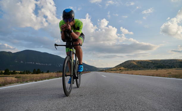 istock triathlon athlete riding bike 1276874516