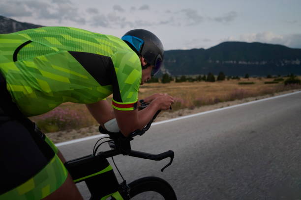 istock triathlon athlete riding bike 1276874522