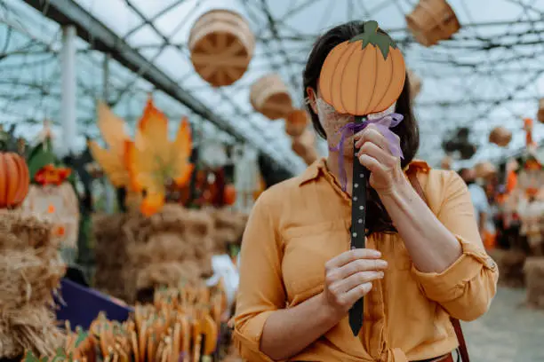 Woman on farm buying Halloween decoration