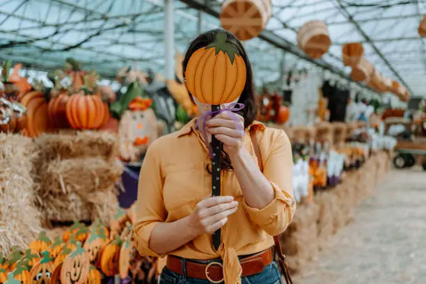 Woman on farm buying Halloween decoration