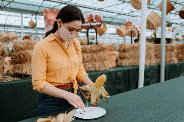 Woman on farm buying Halloween decoration