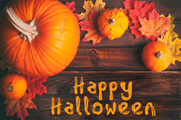 istock Autumn leaves and pumpkin on rustic wooden table 1276876171