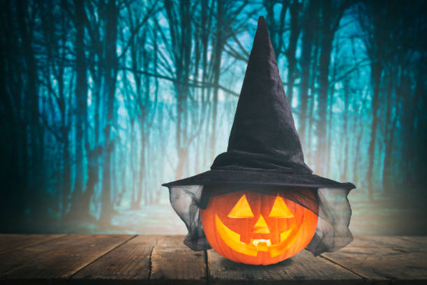 istock Pumpkin Burning In A Spooky Forest At Night - Halloween Background 1276876188