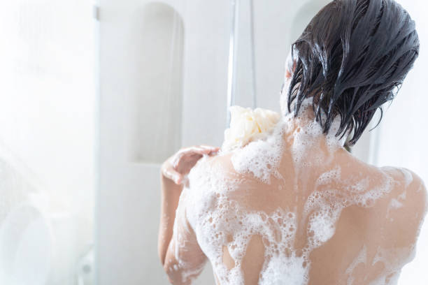 asian woman washing hair and showering in the bathroom - soap body imagens e fotografias de stock