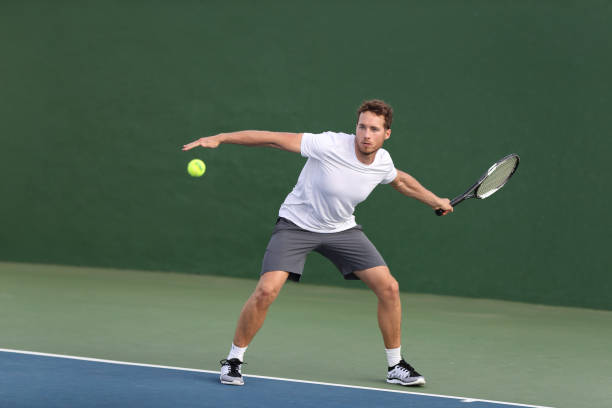 professional tennis player athlete man hitting forehand ball on hard court playing tennis match. sport game fitness lifestyle person living an active summer lifestyle. - volleying sport summer men imagens e fotografias de stock