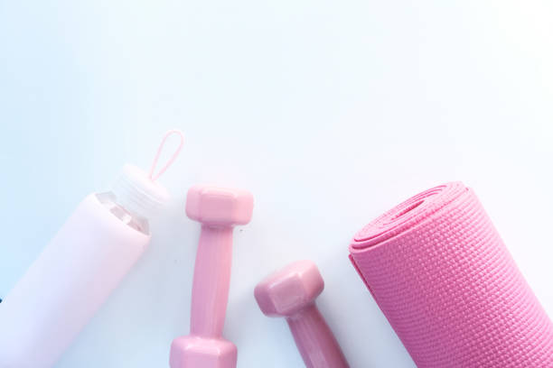 istock pink color dumbbell, exercise mat and water bottle on white background 1276886083