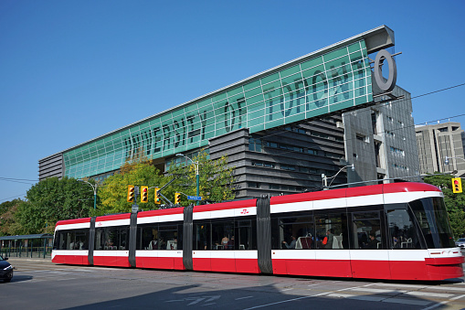 Toronto, Canada - September 25, 2020: A view of the University of Toronto's downtown campus from its western entrance on Spadina Avenue, with the light rapid transit tram right of way.