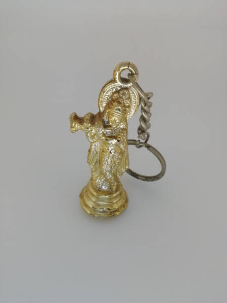 istock closeup view of shiny micro statue of Lord Krishna attached with a chain 1276890214