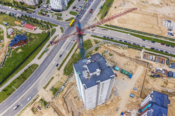 istock crane working on under construction high-rise building. birds eyes view 1276890891