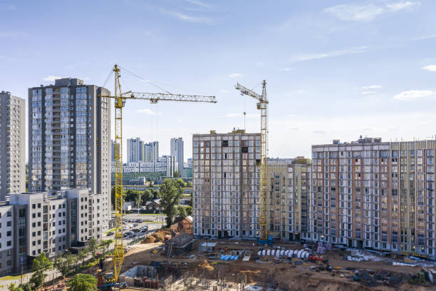 istock new residential buildings under construction. two tower cranes against blue sky 1276890944
