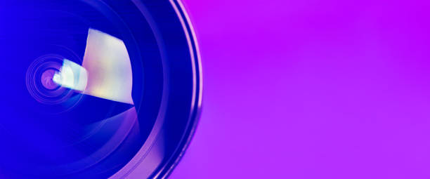 istock .Banner. The camera lens with purple backlight. Optics. 1276891965
