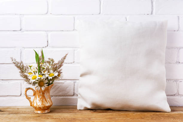 istock Pillow mockup with daisy and green grass 1276892169