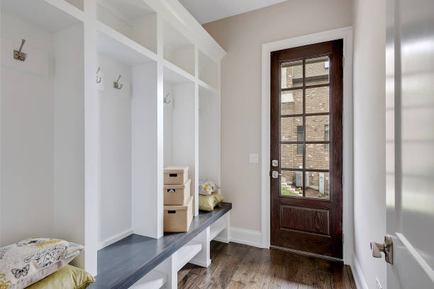 Mud room with glass door leading to the exterior Hardwood flooring with cubbyhole lockers coat hook photos stock pictures, royalty-free photos & images