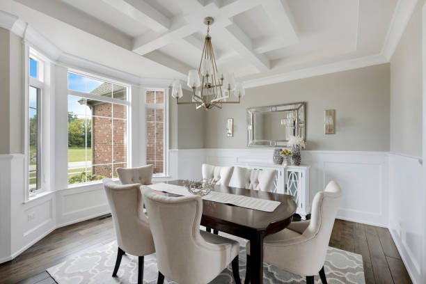 White coffered ceiling in spacious dining room Bay window allowing in lots of natural light dining room stock pictures, royalty-free photos & images