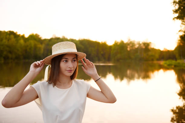 istock Girl on wooden pier. Reads a book. Distance Learning. Quarantine. 1276899048
