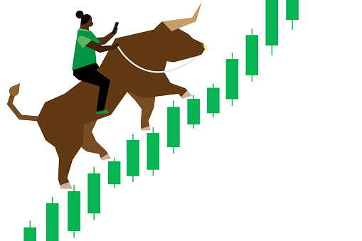 A woman of color is depicted trading stocks on her smartphone while riding a bull up a green bullish (upward trending) Japanese Candlestick style stock chart.