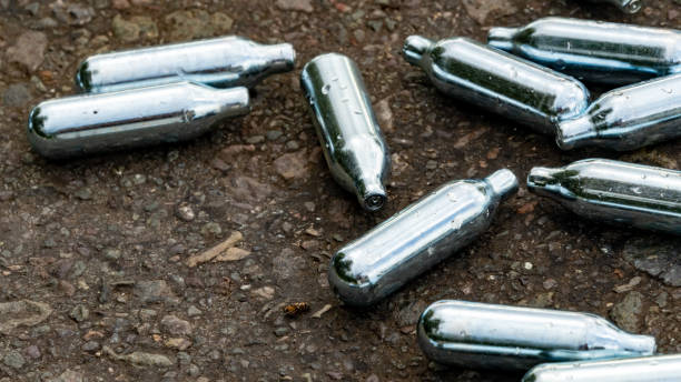 istock Nitrous Oxide used gas canisters discarded on the roadside 1276908325