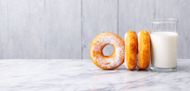 istock Donuts with glass of milk on marble table. Grey background. Copy space. 1276908439