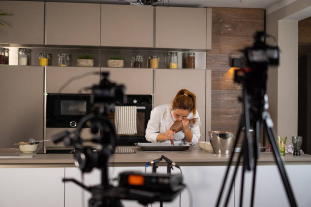 istock female cook influencer during video recording in kitchen 1276909345