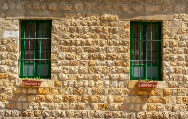 Taanayel/Lebanon - 09/20/2020: facade of the old Jesuit monastery in Taanayel, Bekaa valley with green lattice windows