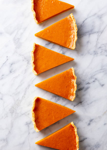 istock Pumpkin pie, tart pieces for Thanksgiving day. Marble background. Top view. 1276909538
