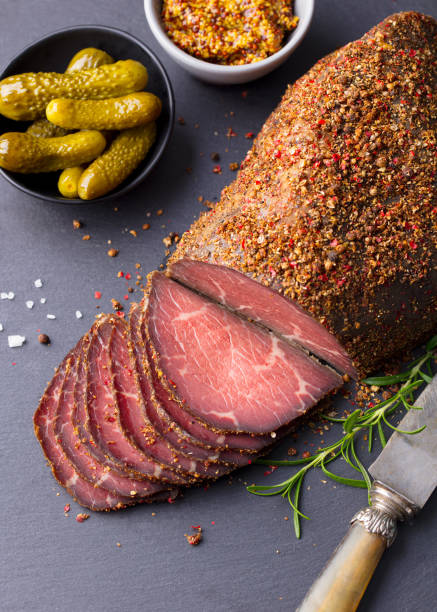 Roasted beef, pastrami on slate cutting board. Top view. Roasted beef, pastrami on slate cutting board. Top view. pastrami stock pictures, royalty-free photos & images