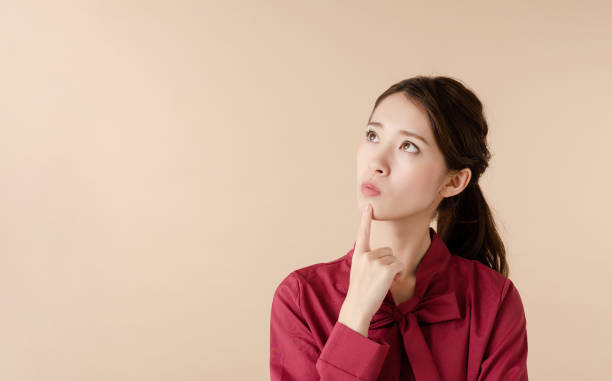 Thinking asian girl. Thinking asian girl. riddle stock pictures, royalty-free photos & images