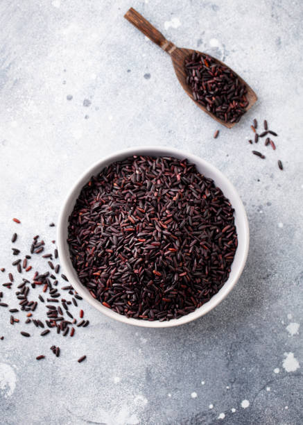 istock Black wild rice in a bowl. Grey stone background. Close up. Top view. 1276911557
