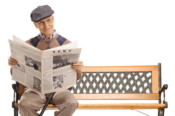 istock Senior man reading a newspaper on a bench 1276911628