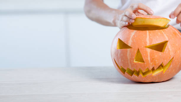 istock Orange halloween pumpkin with carved face 1276914415