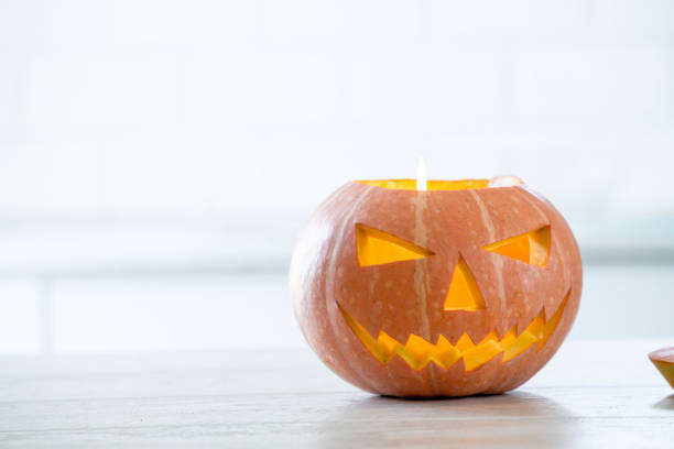 istock Orange halloween pumpkin with carved face 1276914465