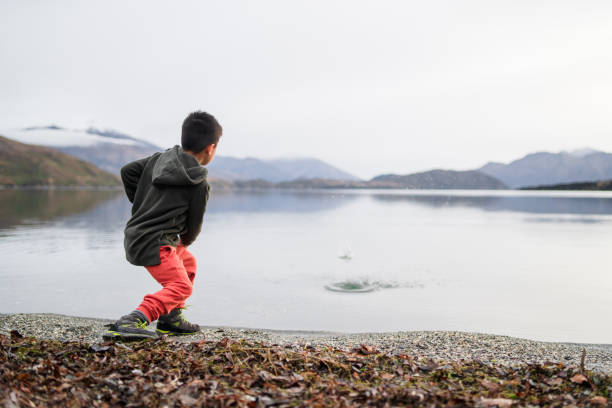 Kid enjoying outdoors at next to Lake Wanaka In South Island, New Zealand.