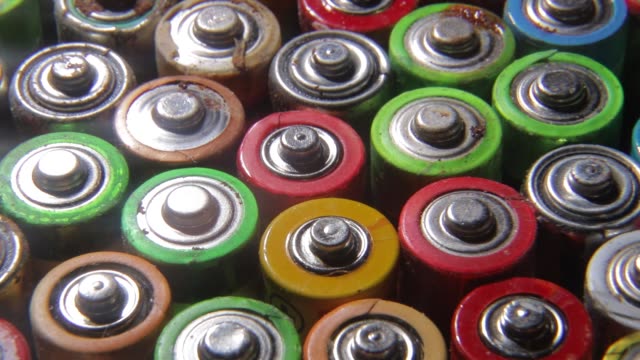 Background from used AA batteries. Pollution of nature