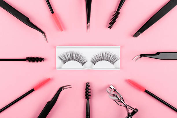 istock Various tools for eye lash extensions on a trendy pastel pink background. Concept. Eyelash curler, tweezers, brushes. Makeup accessories. Cosmetics products. Top view, flat lay. Fake eyelashes. 1276924704