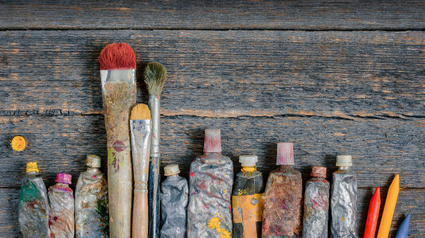 istock Brushes, tubes with paint and colored pencils 1276926821