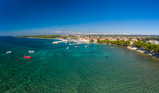 Panoramic aerial drone picture over the Istrian town of Fazana with harbour during daytime in summer