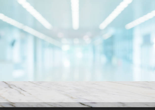 istock Marble stone table top grunge texture background with blurry image inside of shopping mall for product showing. 1276931885