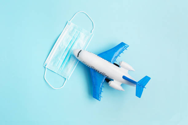 istock Airplane Model with Protective face medical mask 1276932673