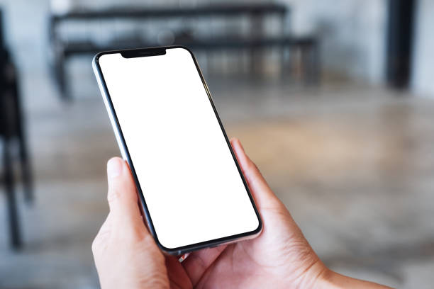 istock a woman holding mobile phone with blank white desktop screen 1276932760