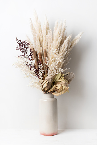 Stylish modern dried flower arrangement in a cream and pink ceramic vase. Including Banksia, pampas grass, bulrush and ruscus leaves. Art deco/Boho gift for Anniversary, birthday, mothers day.