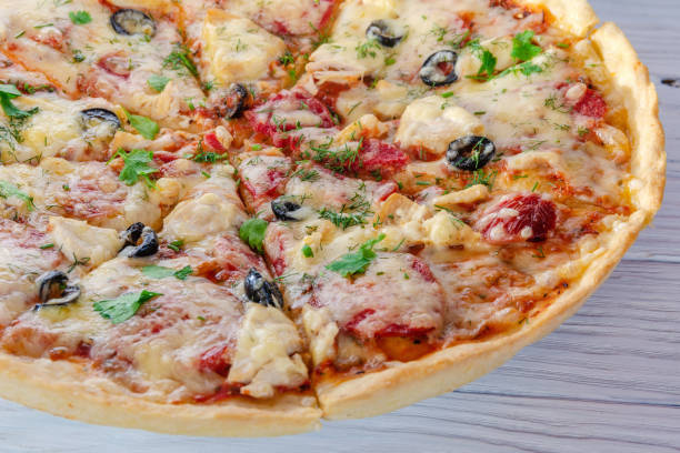 istock pizza with cheese vegetables and meat on a wooden background 1276935151
