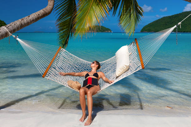 istock woman napping in a hammock on a tropical beach in the Caribbean 1276938136