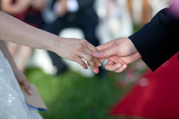 the hand of the bride and groom in love
