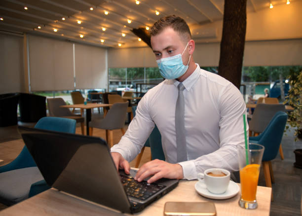 istock Young handsome businessman with face mask 1276938369