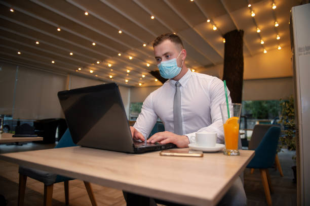 istock Young handsome businessman with face mask 1276938401
