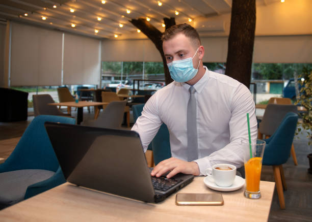 istock Young handsome businessman with face mask 1276938402