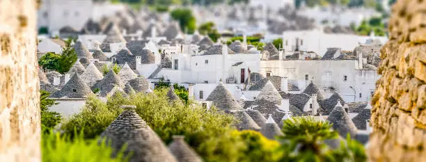 Scenic panoramic view of Alberobello town and its typical trulli buildings, Apulia, Italy. Tilt-shift effect applied