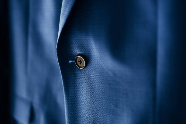 istock A close-up of a black button on a blue men's jacket. 1276939880
